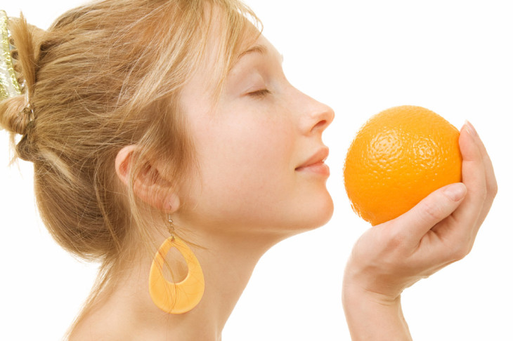 woman holding an orange