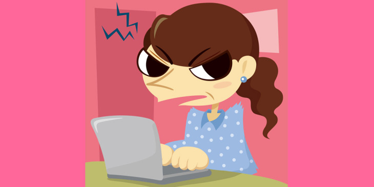 woman scowling using laptop
